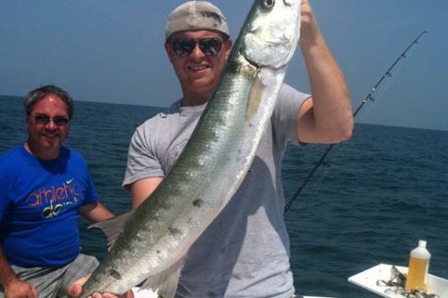 a man holding a fish in the water