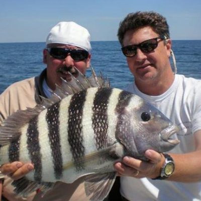 a man holding a fish in the water