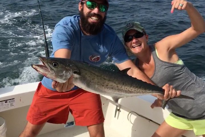 a man holding a fish in the water