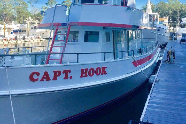 a boat is docked next to a body of water