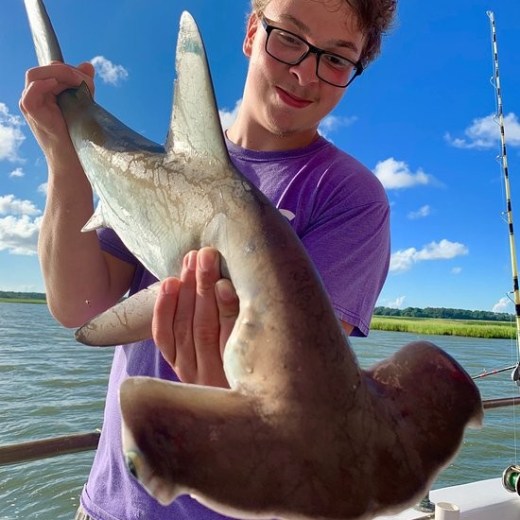 a man holding a fish in the water