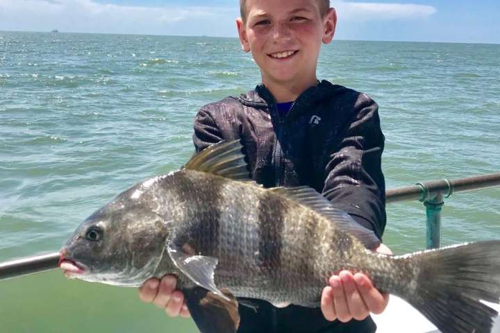 a man holding a fish in the water
