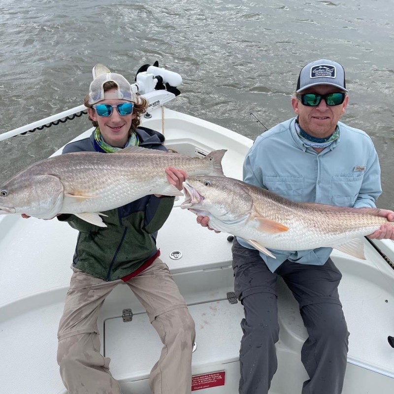 a person holding a fish on a boat