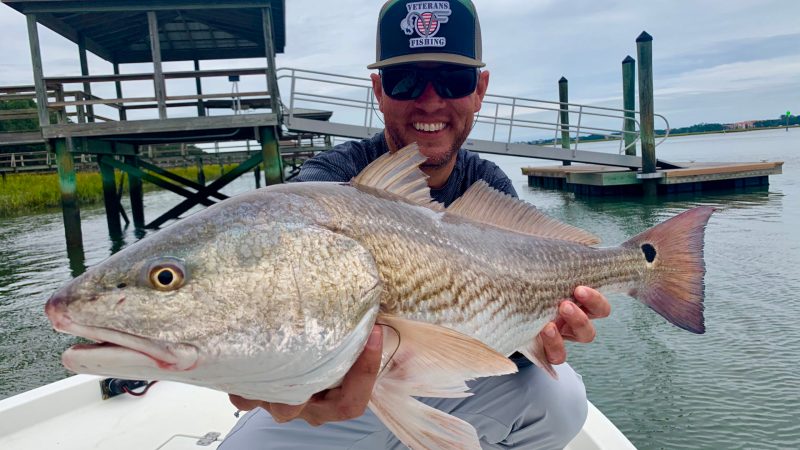 redfish galewarning charter fishing hilton head island a person holding a fish in the water