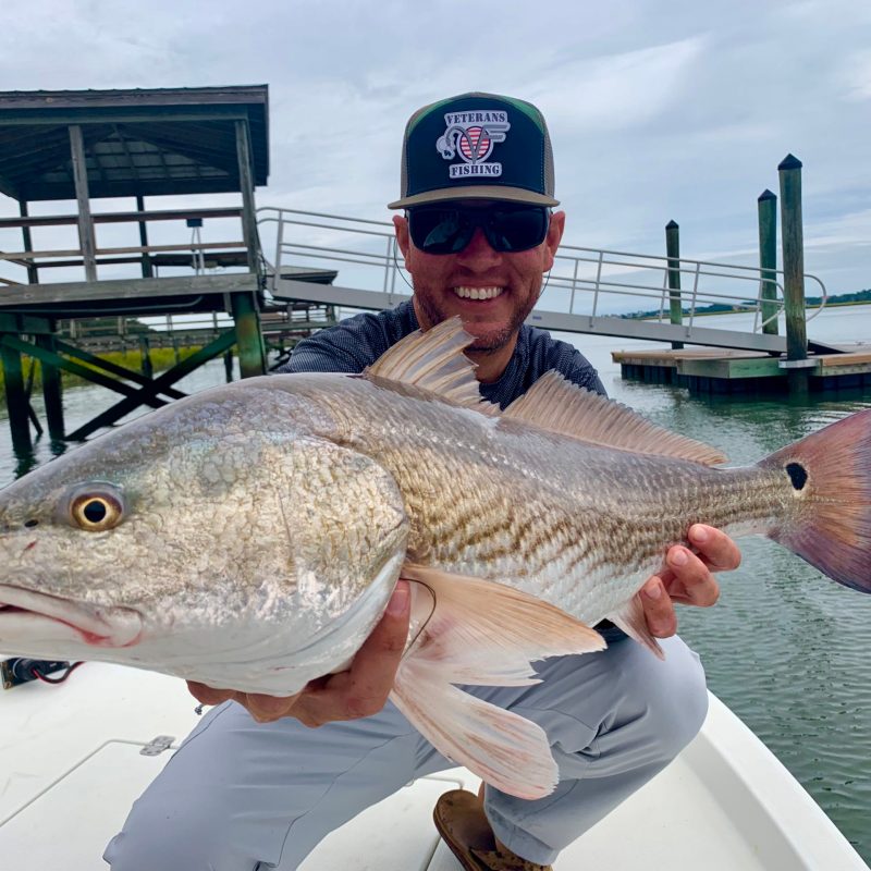a person holding a fish in the water