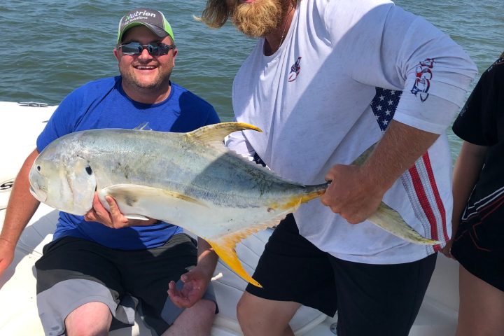 a person holding a fish in the water
