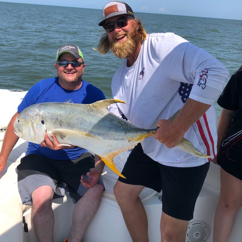 a person holding a fish in the water